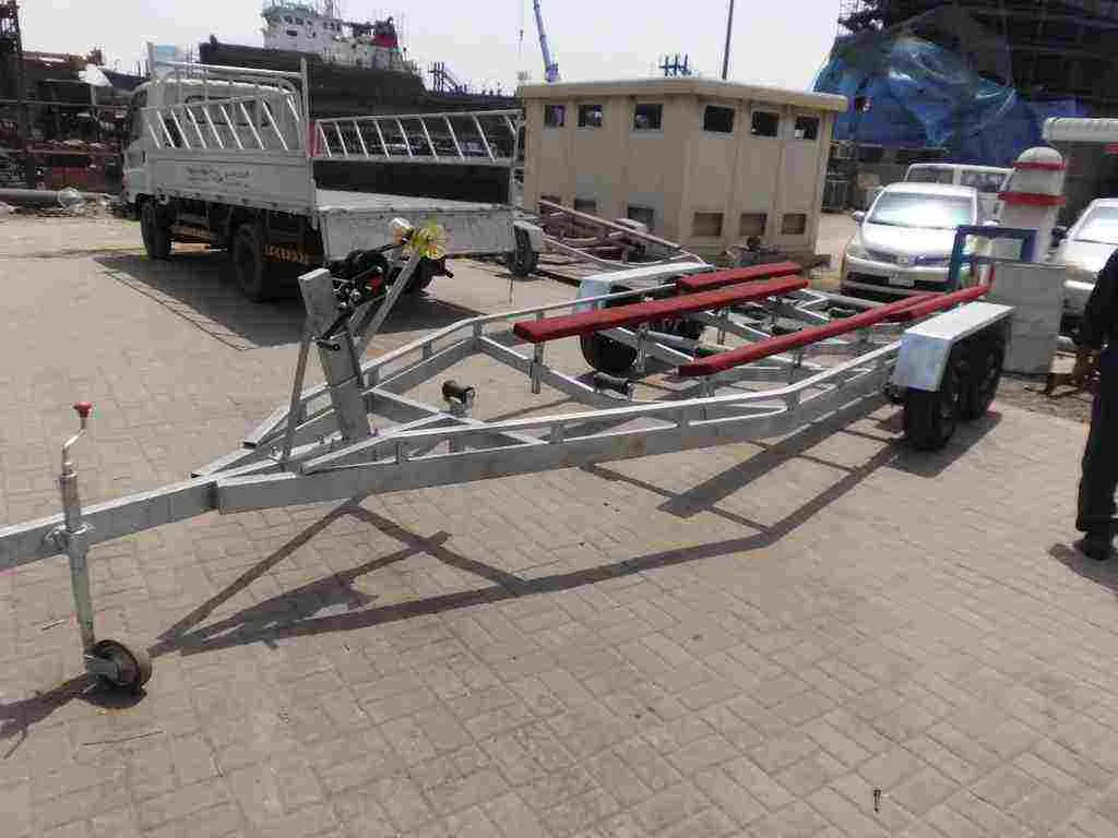 Galvanised triple-axle boat-transport trolley fabricated and finished at the Saham workshop, photographed at the marine yard.